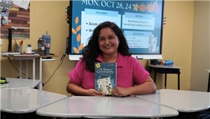 SMS teacher holding book